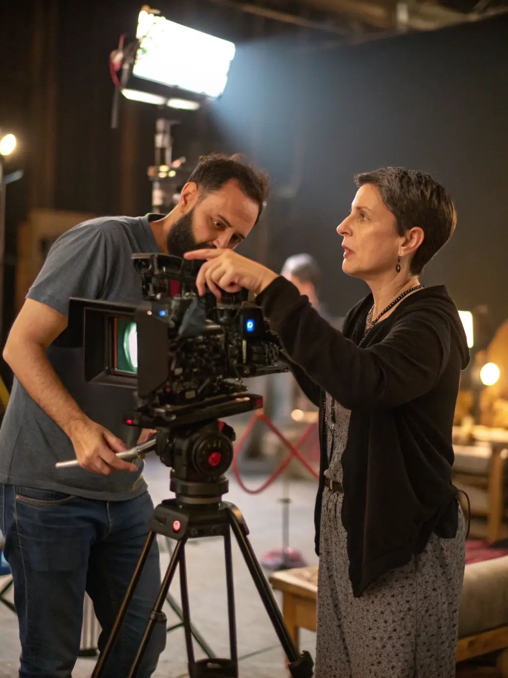 A still from a film set, showing a director and composer in discussion, emphasizing the collaborative nature of film music creation.